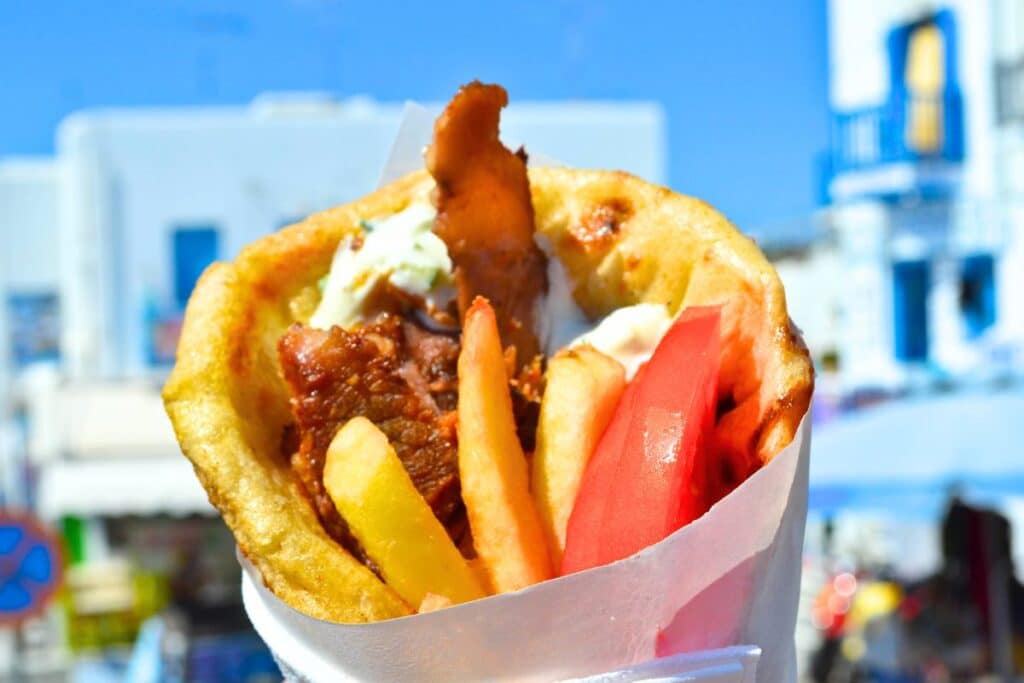 A Greek gyro loaded with meat, tomatoes and french fries on Mykonos