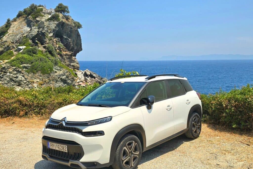 White rental car with Mamma Mia chapel in the background